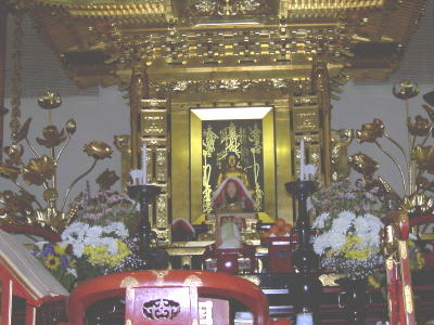 Main altar flush with flowers and fruit in offering to the Three Jewels for the O'Higan Ceremony [celebrating Spring]