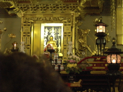 Main altar during service, person's head in foreground