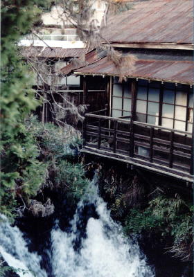 Old covered walkway crossing the creek near the Main Gate of Taisekiji